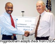 Higginbotham, left, accepts USDA check