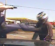 Officer kicks motorcyclist